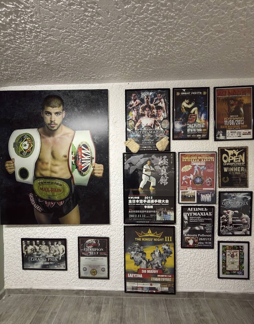 Inside Kallistis Fight Academy — champion wall and fight posters